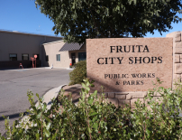 a brick sign that reads, Fruita City Shops, Public Works and Parks