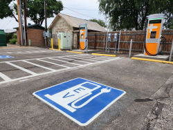Parking lot with an electric vehicle charging station sign